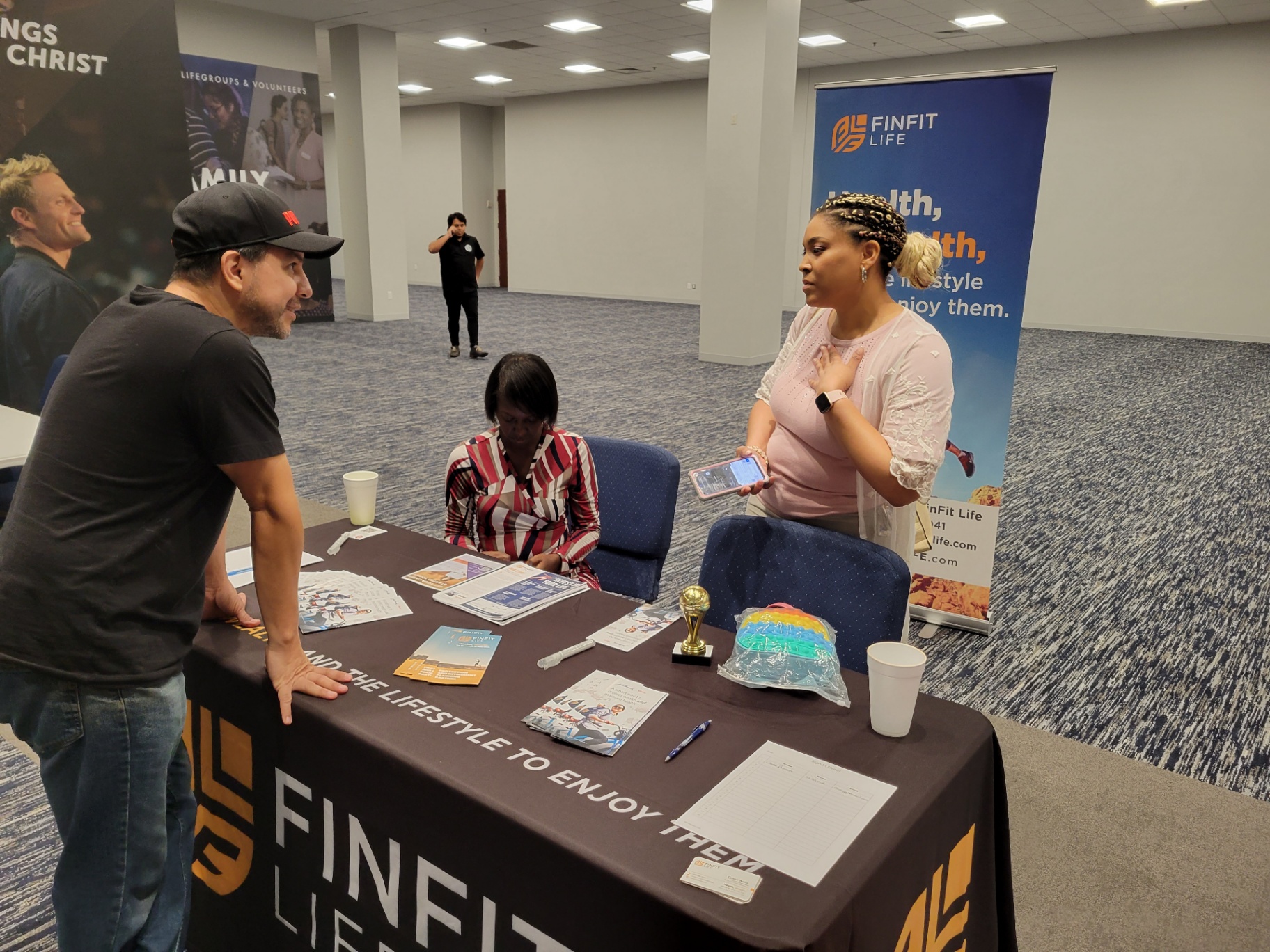 Corey Artisi greeting community members at an outreach event