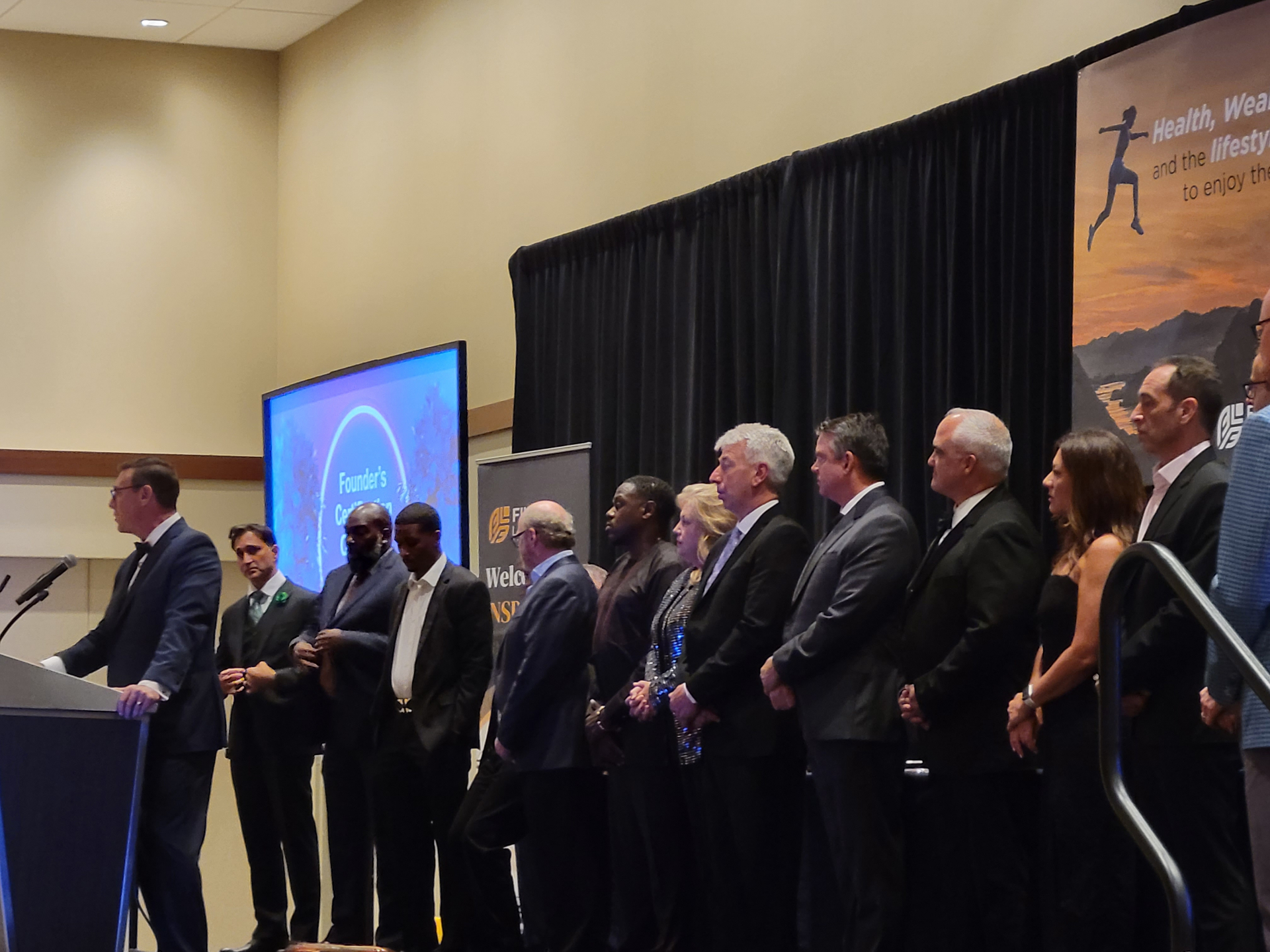 Artis Insurance Group leadership recognized on stage at the FinFit Leadership Convention