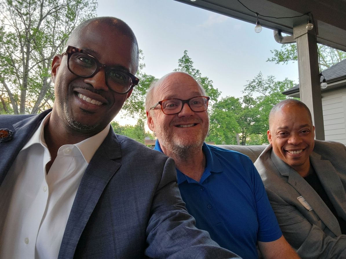 Corey Artis with FinFit Life leadership enjoying an evening together on an outdoor patio