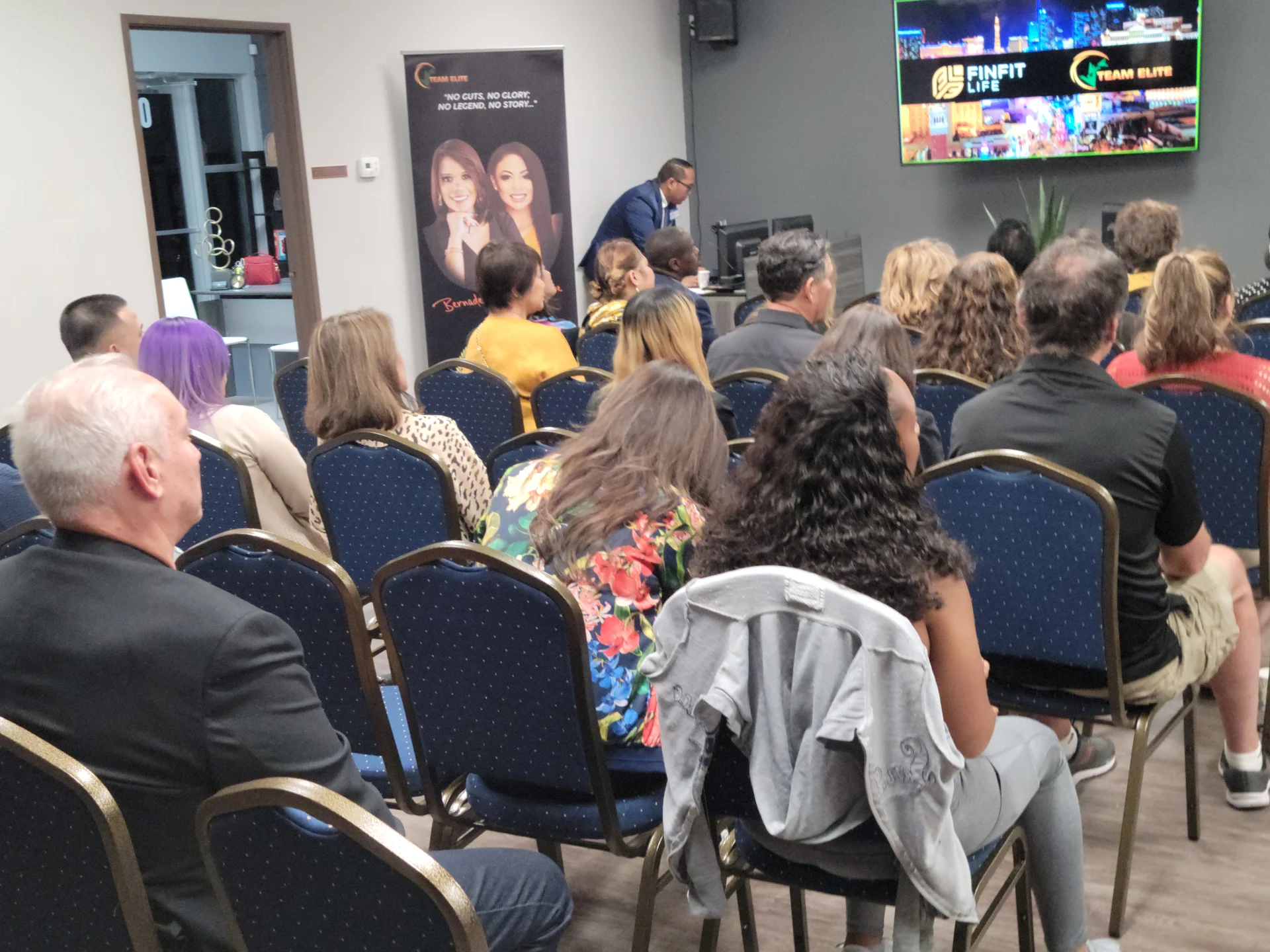 Attendees seated at a FinFit Life and Team Elite presentation watching the speaker