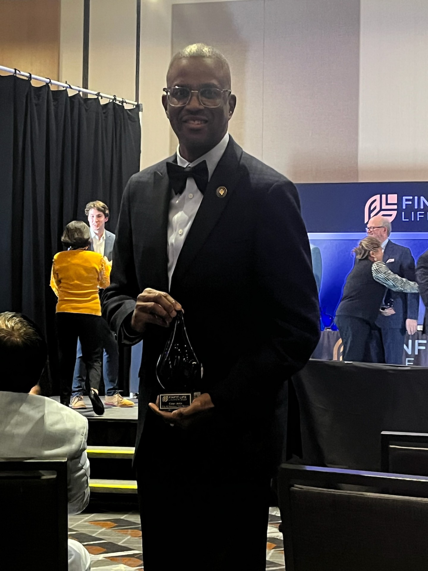 Corey Artis receiving a leadership and production award