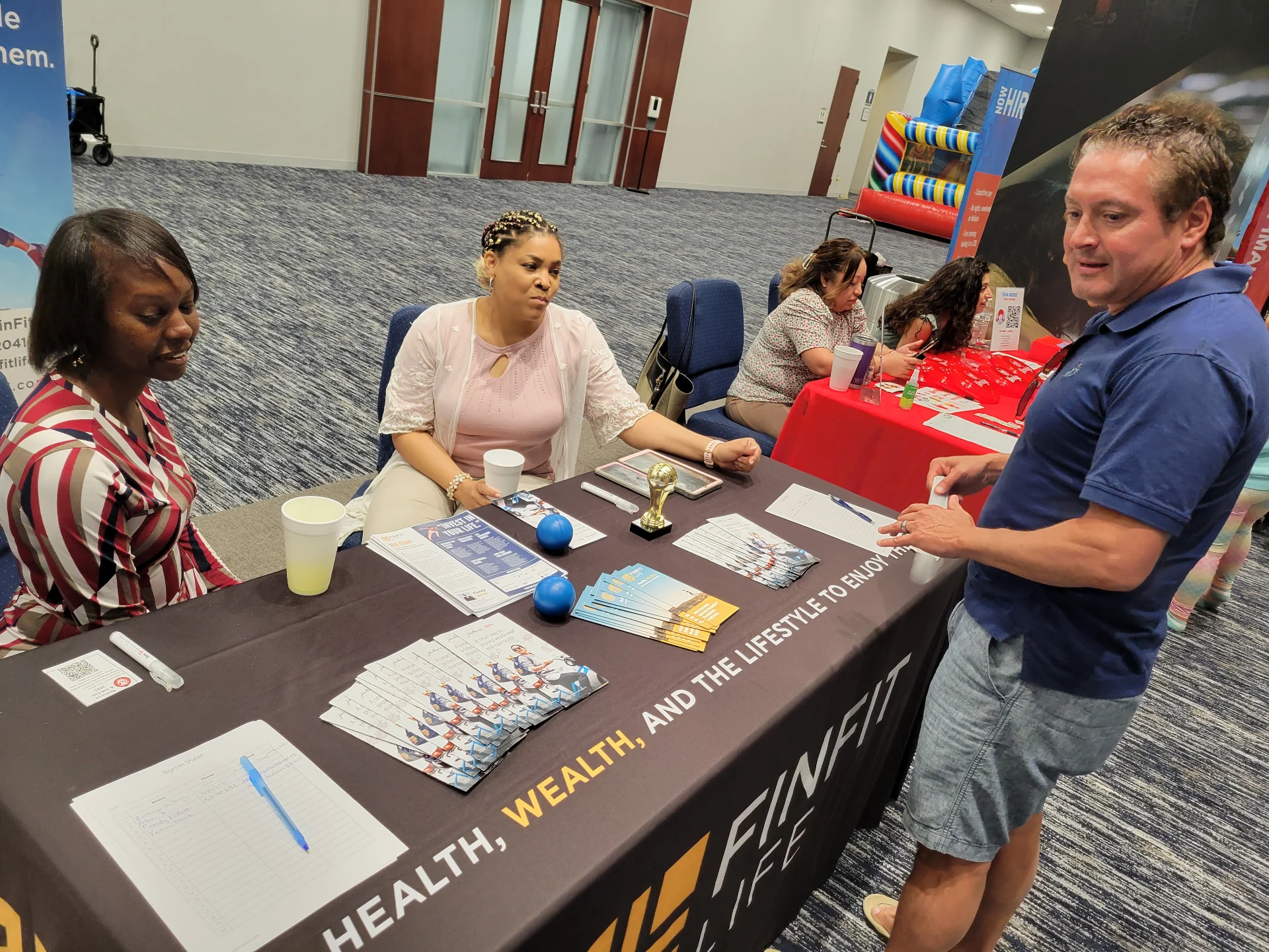 Corey Artis team engaging community members at the FinFit Life Health, Wealth & Lifestyle outreach booth